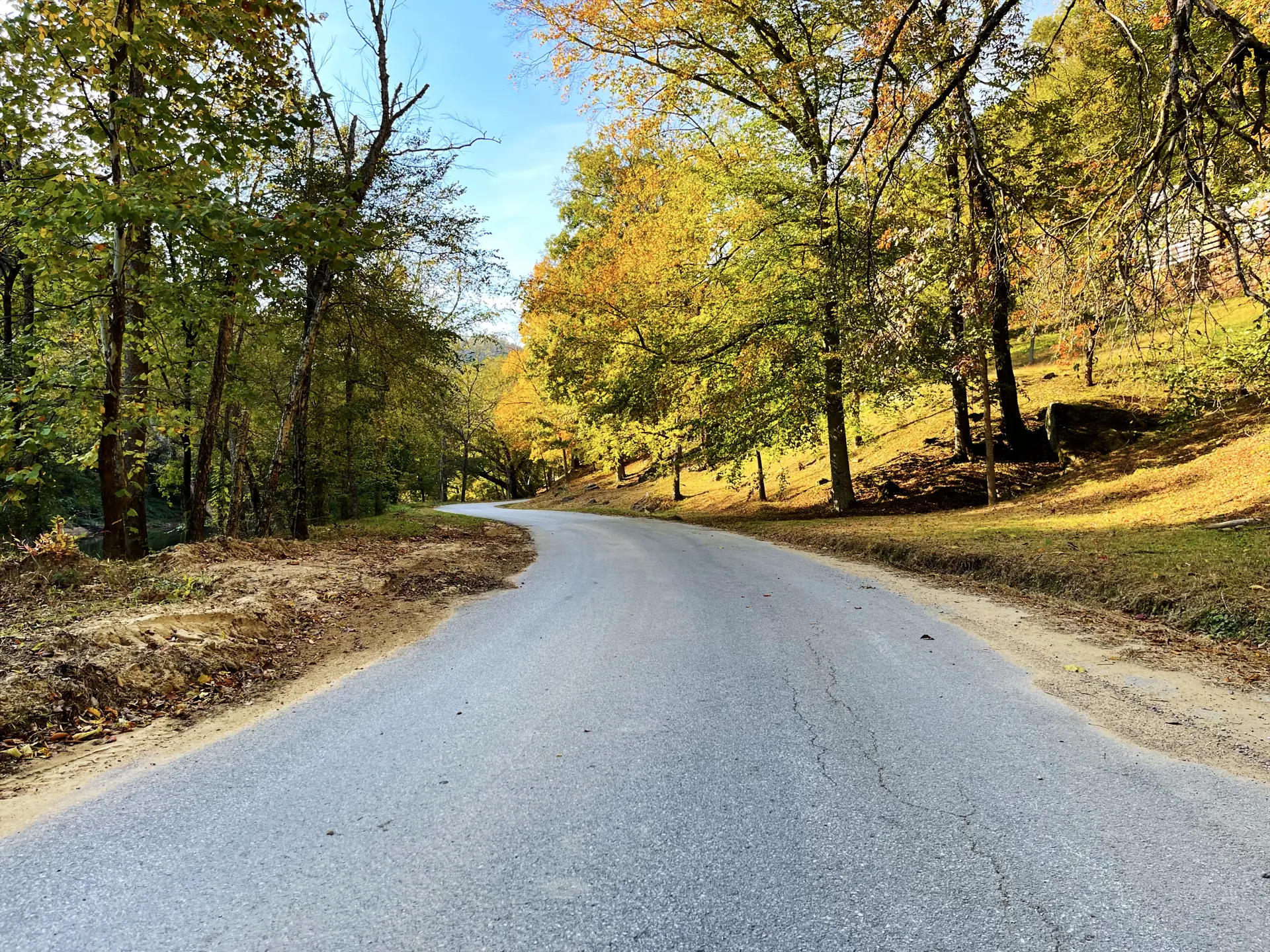 Autumn road leading to Wendover through golden foliage